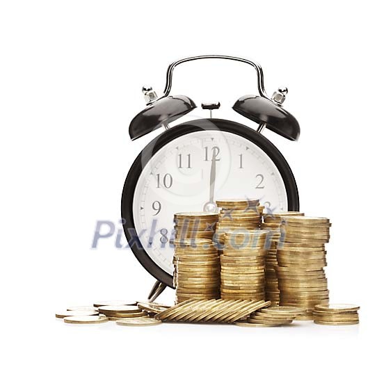 Isolated stacks of coins in front of a clock
