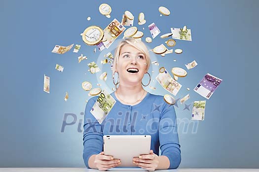 Woman sitting by her desk surrounded by flying money