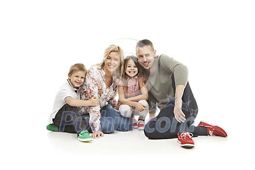Smiling family sitting on the floor