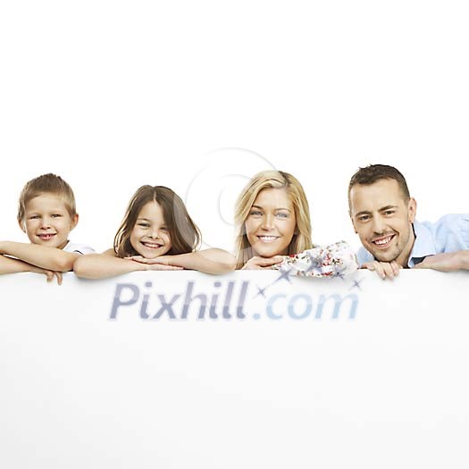 Smiling family behind a poster