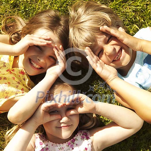 Children covering their eyes from sun