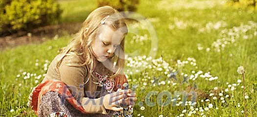 Girl picking flowers on the meadow