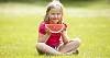 Girl sitting and holding a slice of watermelon