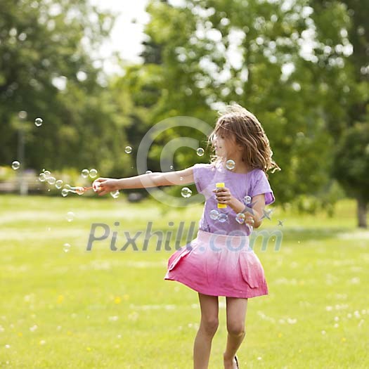 Girl in the park makinb soap bubbles