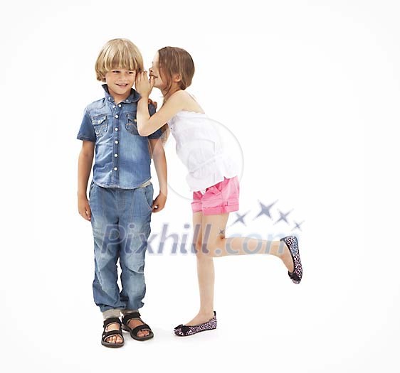 Isolated girl whispering in to a boys ear