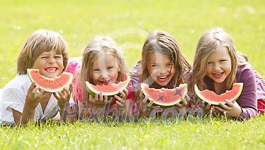 Children having slices of watermelon