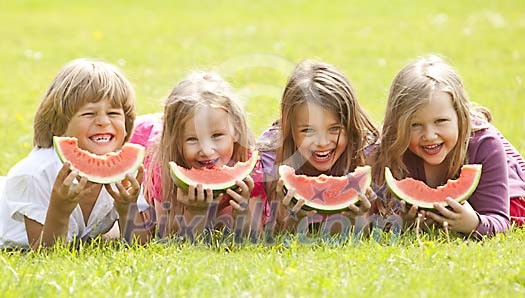 Children having slices of watermelon Children having slices of watermelon