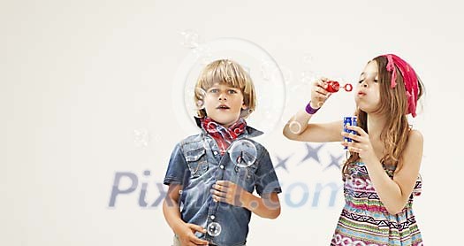 Boy and a girl with soap bubbles