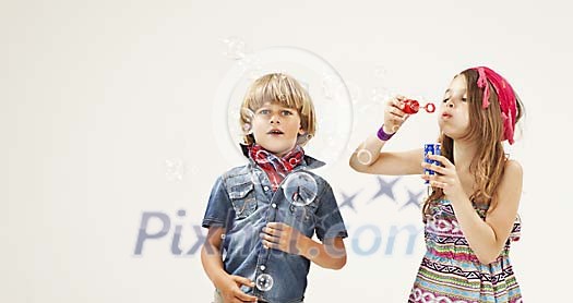 Boy and a girl with soap bubbles Boy and a girl with soap bubbles