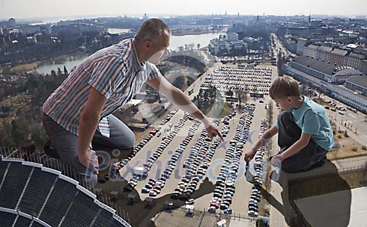 Father and son playing with real cars
