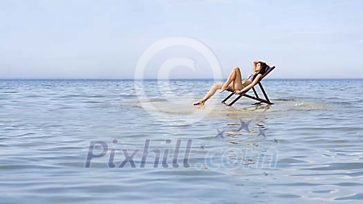 Woman sunbathing on a small island