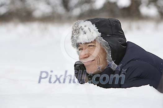 Smiling man dreaming in snow