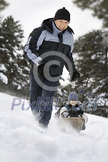 Father sledging with his son Father sledging with his son
