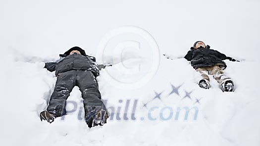 Two people making snow angels