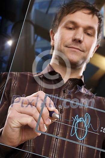 Man writing a signature on the glass screen