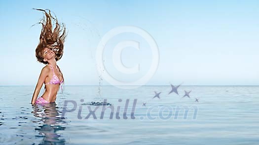 Woman in the water throwing her hair back