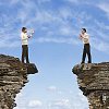 Two men argueing over the gap in the rocks