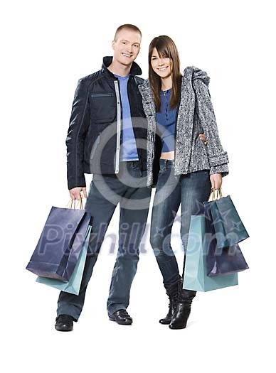 Young couple posing with many shopping bags