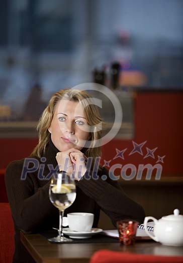 Woman sitting in cafeteria
