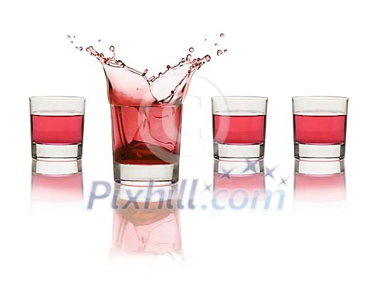Four red drinks, one splashing