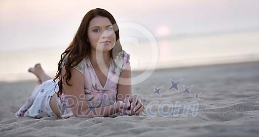 Young woman lying on the beach in sunset Young woman lying on the beach in sunset