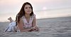 Young woman lying on the beach in sunset