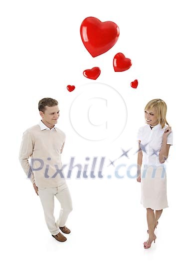 Couple in white with shy smiles and flying red hearts between them