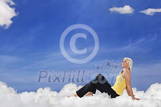 Young woman sitting on clouds