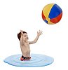 Boy standing in water and playing with beach ball on white