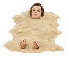 Boy buried in sand on white