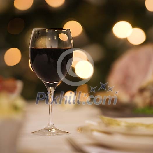 Glass of red wine on dinner table 