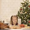 Little girl having christmas dinner at home