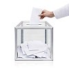 Hand placing the voting slip in to a voting box