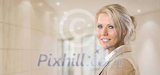 Beautiful businesswoman in a blurred office hall Beautiful businesswoman in a blurred office hall