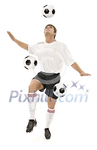 Football player training with three balls simultaneously