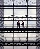 Business men greeting in a modern spacious office building