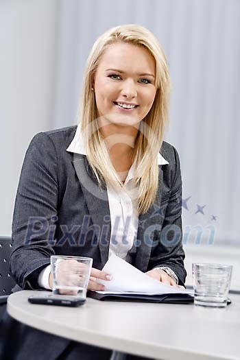 Young business woman behind a meeting table