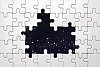 White puzzle with missing pieces in front of space view