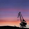Silhouette of a big crane in dawn