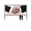 Two business persons in front of a giant display with shaking hands
