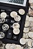 Euro coins on calculator keyboard