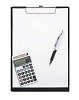 Pen, calculator and empty white paper on a black notepad