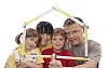 Family looking through a house shaped carpenter's measure