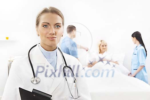 Female doctor, nurses and patient in a light hospital room