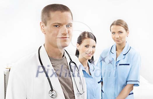 Half body portrait of male doctor and two female nurses