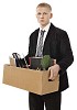 Sacked employee carrying a box with office supplies