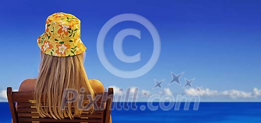 Single woman in a beach chair by blue sea