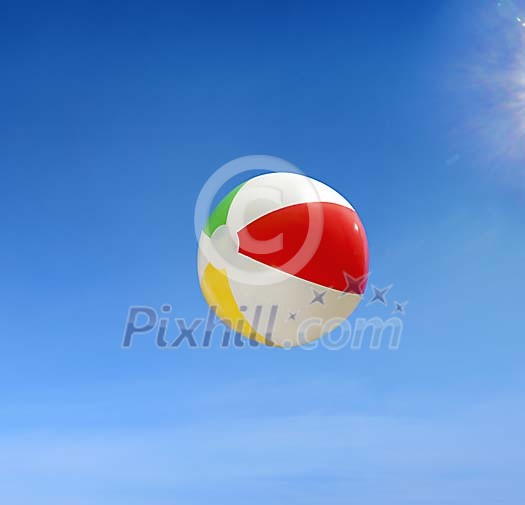 Beach ball flying against blue sky