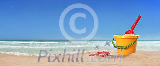 Childrens toys on beach panorama