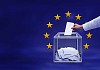 Voting box and hand in front of the European Union stars background